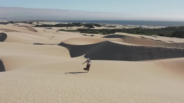 AR Game Outdoors Woman in Virtual Reality Headset and Controllers Painting alt