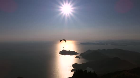 Paragliders Flying With Paragliding in Sky Over the Forest, Mountain Top and Sea alt