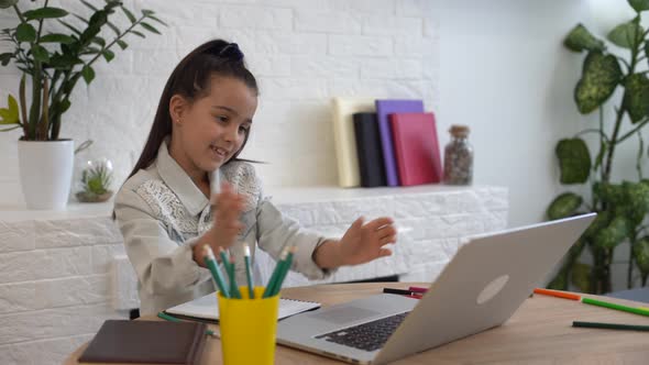 Closeup Photo of Little Pretty Pupil School Talk Skype Notebook Online Lesson Video Call Sit Desk alt