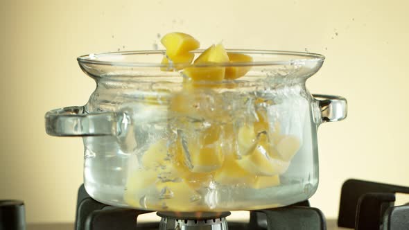 Super Slow Motion Shot of Sliced Potatoes Falling Into Boiling Water at 1000 Fps. alt