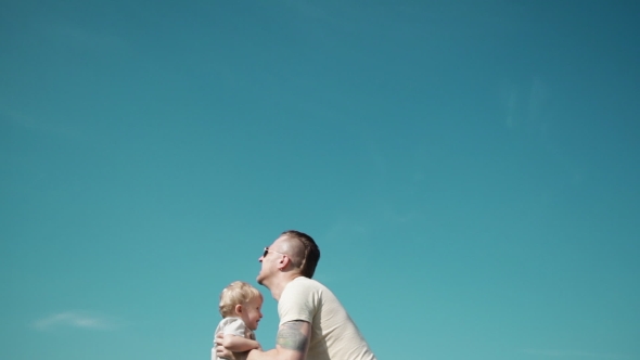 Father Playing With His Son - Throws It High Into The Sky alt