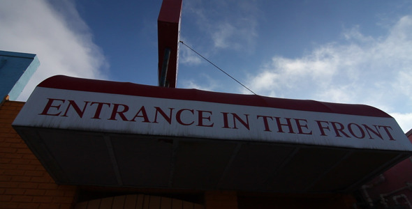 Entrance In Front Sign Under Clouds