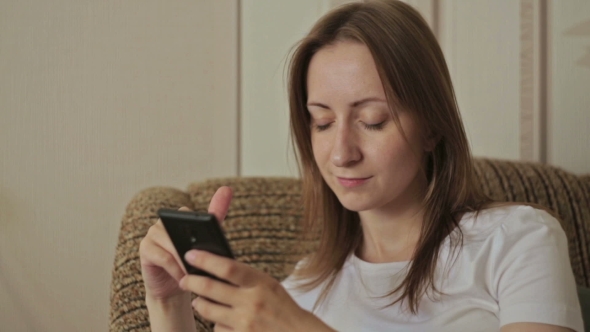 Young Beautiful Woman Using Smartphone In Home