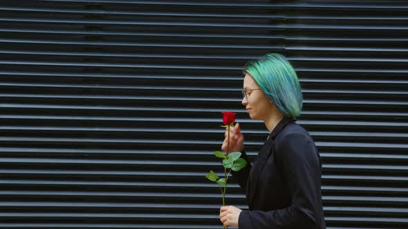 Girl Going at Street Inhales Fragrance of Red Rose alt
