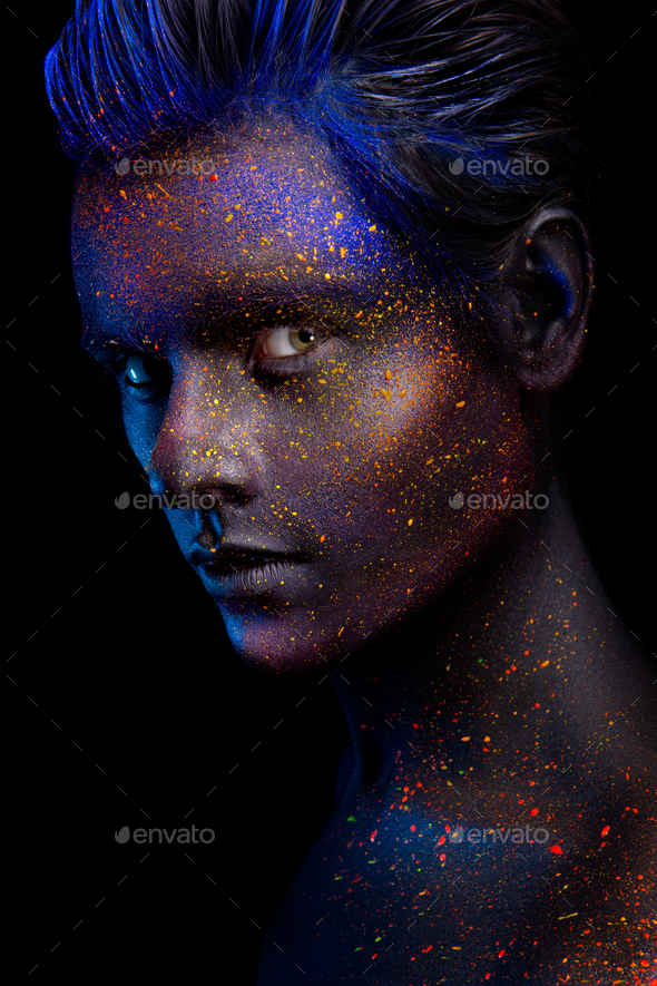 Glowing neon makeup with dramatic look in his eyes. - Stock Photo - Images