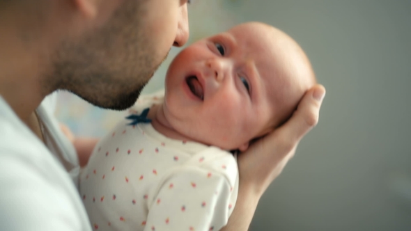 Father Holding Newborn Baby Girl