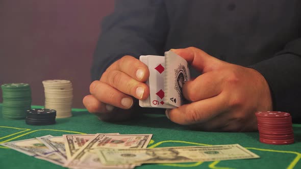 Hands of a Risky Poker Player Closeup Slowly Fingering a Deck of Cards alt