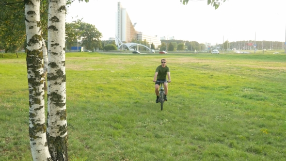 Bikes Cycling Man. A Young Man Stops And Looks At Smart Watches. He Checks Messages About Birch alt