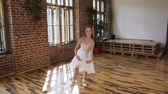 Young Ballet Dancer in white Dress and Ballet Shoes Performs Elements of Ballet alt