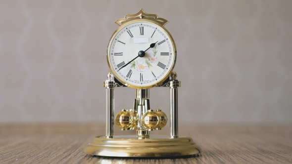 Clock With a Pendulum In a Form Of Rotating Balls