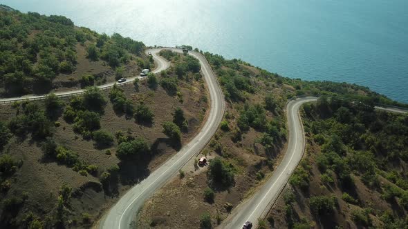 A Winding Road Through the Crimean Mountains Along the Sea alt
