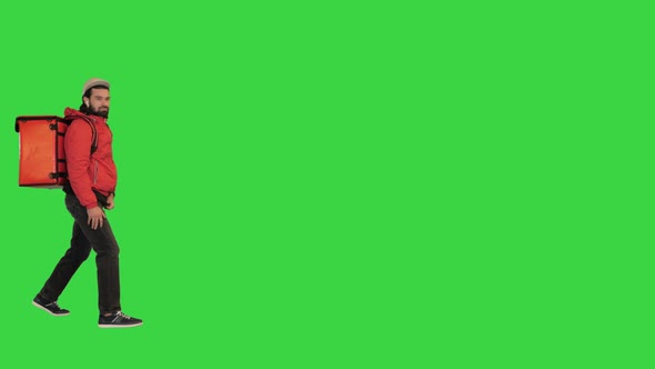 Delivery Man Walking Outdoors in a Strong Wind Hard Weather Conditions on a Green Screen Chroma Key