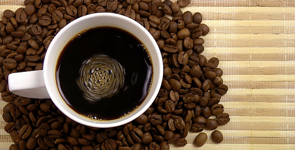 Cup of Coffee and Coffee Beans on Bamboo Background