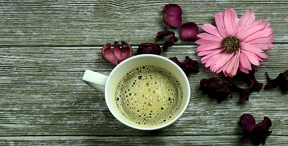 Cup of Coffee with Flowers on Wooden Background