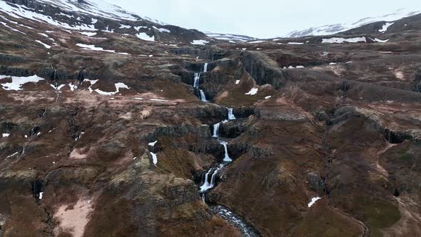 Pullback Over Series Of Waterfall At Klifbrekkufossar In Mjoifjordur River, Eastern Iceland. Aerial alt