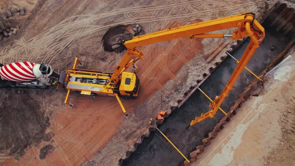 Concrete Mixer and Another Construction Machine Working on a New Expressway alt