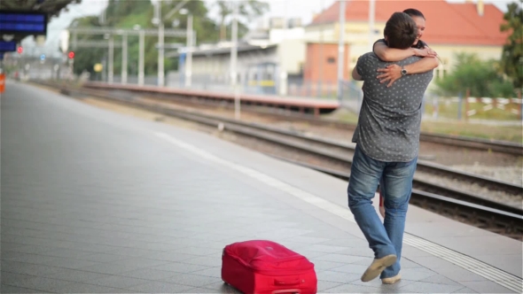 Young Couple Happy To Meet Again In The Train Station, Girl Runs To Meet Her Boyfriend And Throws a alt