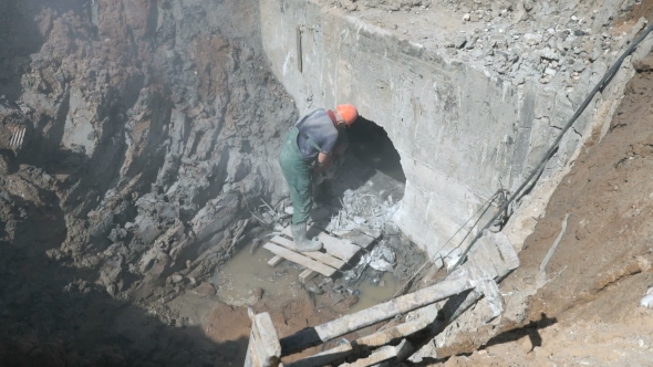 Worker Repairing The Construction Collector