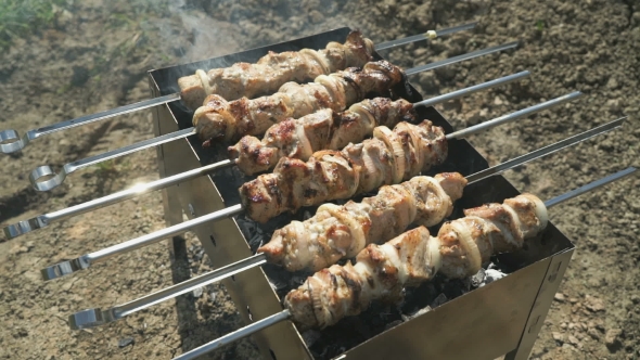 Meat Prepares On Metal Skewers On Coals Outdoors alt