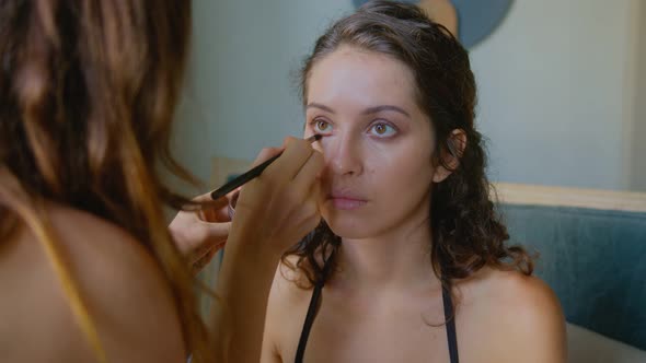 A Makeup Artist Makes a Bright Makeup for a Beautiful Girl Model alt