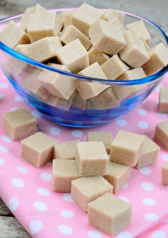 Beige sugar cubes in a transparent bowl