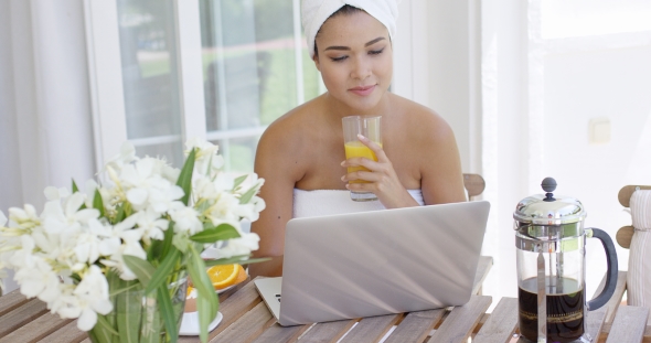 Woman In Towel With Laptop Having Breakfast alt