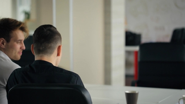 Young Attractive Blond Woman With a Light Blue Blouse Of Sit Table For Interviews With Men On Job