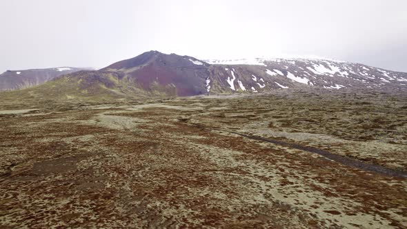 Aerial Shot of Beautiful Snowy Mountain Peak and Immense Land Covered ...