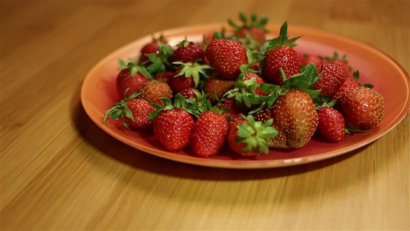 Taking a Strawberry From Plate