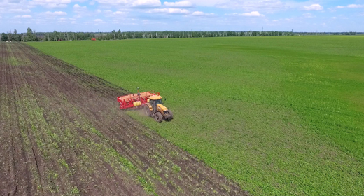 Agriculture seeder and tractor work on the field aerials and dolly shots