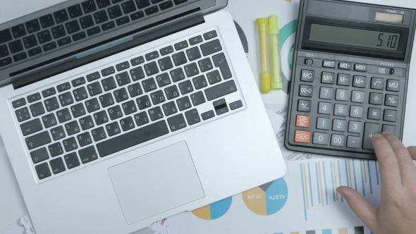 Businessman Hands Work With Calculator And Typing On Laptop Computer Keyboard. alt
