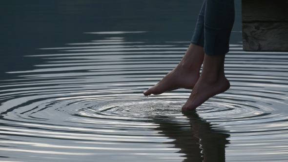 Female Feet Touching Water