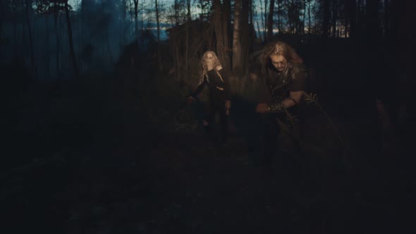 Flashlight Illuminating Terrible Couple Zombie Walking in Night Forest alt