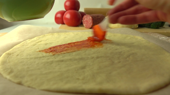 Spreading Tomato Sauce Over Dough Base. Cooking Homemade Pizza, Part Of The Set alt