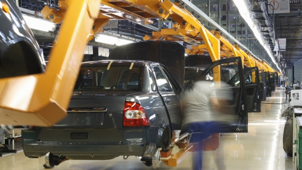 Female Worker Assembly Cars On Conveyer