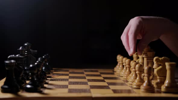Opening Queen Gambit of the chess game with the move of the white pawn d2-d4, black background