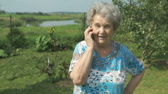 Old Woman 80s Telling On The Smartphone Outdoors