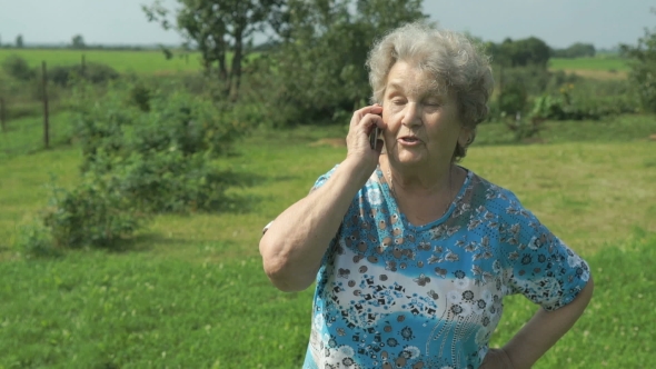 Old Woman 80s Telling On The Smartphone Outdoors