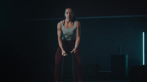 Young Girl Training with Battle Rope in Sport Gym on Battle Ropes Session alt