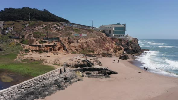 Aerial rising push-in shot of the Cliff House next to the ruins of the Sutro Baths at Land's End, Sa alt