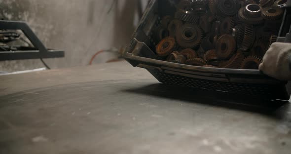 Technician Empties the Metal Gears From the Box in Slow Motion to the Crafting Table  60p Prores HQ alt