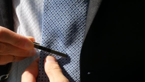 The Guy Puts On Tie Clip