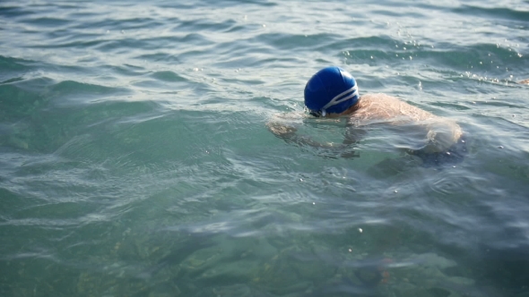 Child Teen Boy Swims In The Sea Water