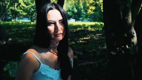 Woman Brunette With a Nice View. Against The Background Of The Nature