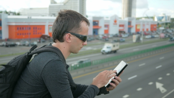 Outdoor Portrait Of Modern Young Man With Digital Tablet In The Street