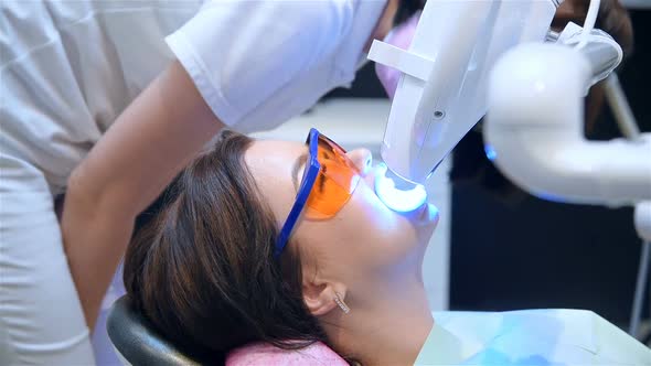 Doctor Is Watching On Teeth Whitening Procedure