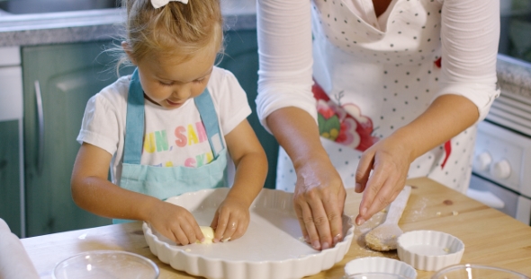 Cute Little Girl Greasing a Baking Dish alt