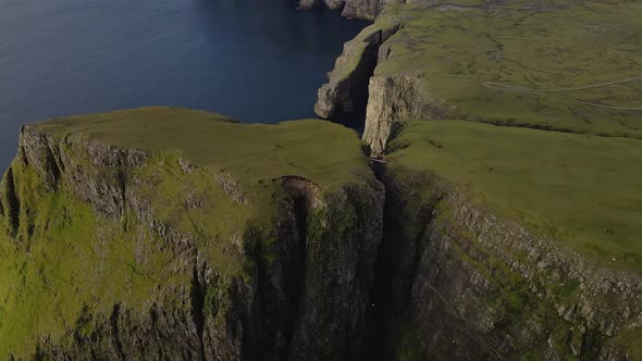 Drone Flight Rising Over Cliff Edges On Coastline alt