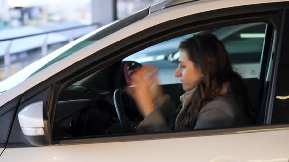 Woman is Angry and Upset on the Steering Wheel Because Her Car Broke Down alt