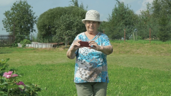 Elderly Woman Taking Photos The Nature Of Park